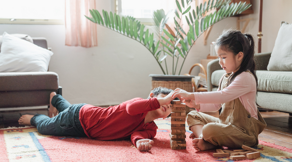 siblings playing indoors