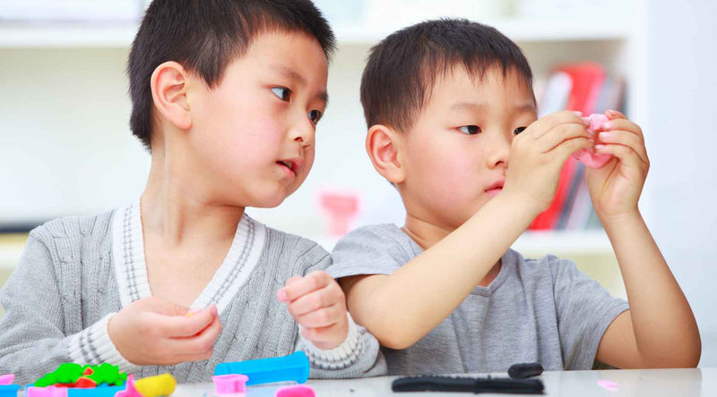 two asian kids playing together